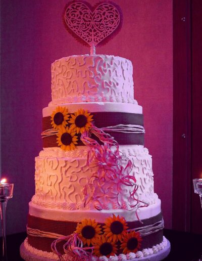 a four layer cake with sunflower