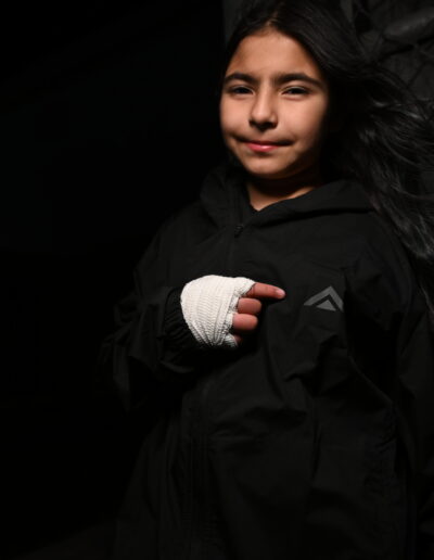 a kid wearing a jacket with a logo
